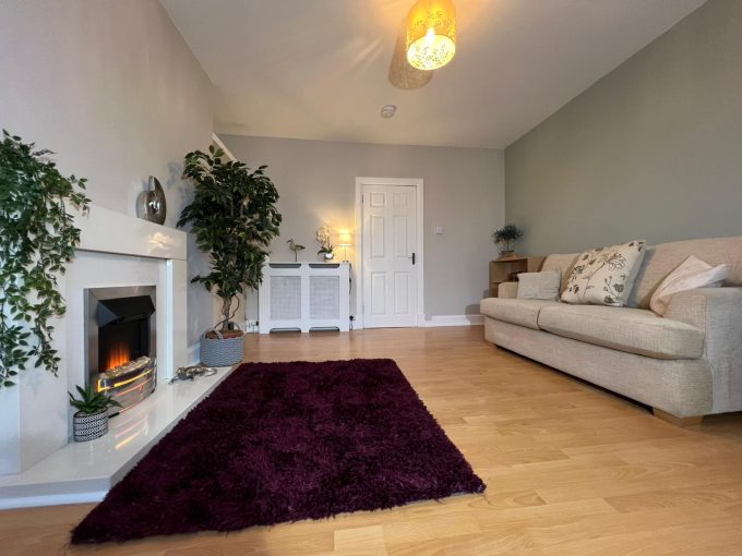 Anderson Road - front living room. Wooden flooring and walls painted in neutral colours.