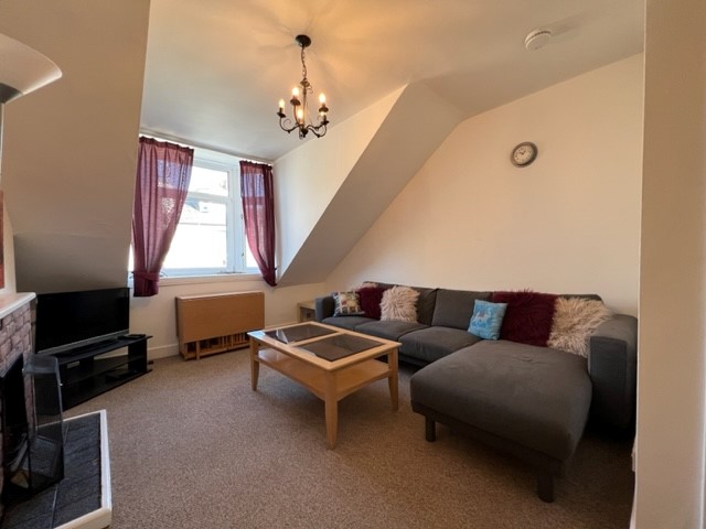 Shared living room with sofa, satellite TV and dining area in Lamond Place HMO